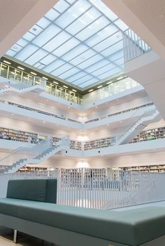 the inside of a large library with stairs and bookshelves in it's center