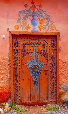 an orange door with ornate designs on it