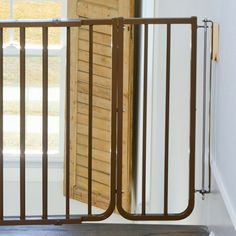 an open wooden gate in front of a window