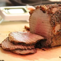 a piece of meat sitting on top of a wooden cutting board