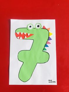 a paper bag with the letter f painted on it and a dinosaur face in the middle