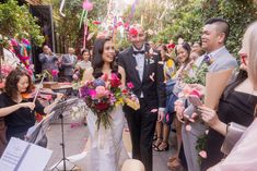 a bride and groom walking through confetti filled streets