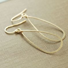 Teardrop hoop earrings, hand formed out of 14k gold filled wire... clean, versatile, and a staple for any jewelry collection. These lightweight, swingy earrings go with everything. Earrings are hammered and tumbled for strength and shine. They fall approximately 2 1/4 inches (5.6 cm) from the very top of the earwire and are about 5/8 inch (1.5 cm) at the widest point. See more~ Hoops and metal jewelry- http://www.etsy.com/shop/aubepine?section_id=6718993 Gold earrings- http://www.etsy.com/shop/a Gold Minimalist Sterling Silver Teardrop Earrings, Minimalist Gold Teardrop Earrings In Sterling Silver, Gold Minimalist Teardrop Earrings With Lever Back, Delicate Teardrop Hoop Earrings For Everyday, Gold Hypoallergenic Teardrop Earrings For Everyday, Gold Teardrop Hoop Earrings Minimalist Style, Minimalist 14k Gold Filled Teardrop Dangle Earrings, Minimalist Gold Teardrop Hoop Earrings, Delicate Gold Wire Wrapped Hoop Earrings