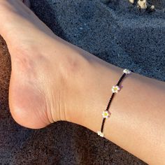 🌊 Handmade in Marina Del Rey, Southern California Daisies at Night Beaded Anklet is perfect for layering with other anklets, on the sandy beach, staycation at home or great to wear with any outfit. Each piece is unique as it is handmade and inspired daily. No two are alike. 🌊 Very Lightweight and comfortable 🌊 Premium quality Glass Seed Beads in size 12/0 (approx. 2mm and 3mm)  🌊 Durable nylon thread or Durable monofilament cord 🌊 Silver plated over alloy lobster clasp  🌊 2" extender chain added upon request Black Round Beads Anklets For Beach, Beaded Ankle Wrap Anklets For Beach, Beaded Ankle Wrap Anklets For Beach Season, Flower Shaped Summer Beach Anklets, Summer Beach Flower Anklets, Flower-shaped Summer Beach Anklets, Summer Adjustable Beaded Bracelets With Black Beads, Black Beaded Bracelets For The Beach, Black Anklets For Summer Vacation