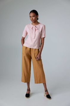 "Get comfortable in these relaxed, slightly flared linen culottes. These wide leg trousers have elastic waist and side pockets. The pockets are accented with decorative seams. The pants would serve you well on all casual occasions or around your house. They can be easily paired with a kimono jacket and an oversized blouse. Made from heavy linen for more solid look and feel. STYLE DETAILS * Relaxed fit * Elastic waist * 2 side pockets * Slightly flared at the bottom * Cropped (ankle length) * Made from heavy linen SIZES & COLORS IN PICTURES * Model 1 wears size S/M in color Honey Yellow. She is 178 cm (5'10\"). Bust - 85 cm (33\"), waist - 63 cm (25\"), hips - 86 cm (34\"). * Model 2 wears size S/M in color Pearl Grey. She is 176 cm (5'9\"). Bust - 83 cm (33\"), waist - 60 cm (24\"), hips - Linen Wide Leg Pants For Daywear, Spring Relaxed Fit Ankle-length Culottes, Casual Culottes For Summer Daywear, Wide Leg Linen Capris, Spring Culottes With Relaxed Fit And Straight Shape, Spring Straight Pants Culottes With Relaxed Fit, Spring Relaxed Fit Straight Culottes, Spring Wide Leg Daywear Capris, Spring Straight Culottes With Relaxed Fit