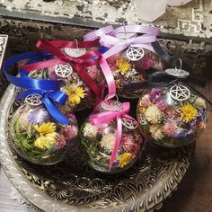 a bowl filled with assorted flowers on top of a table