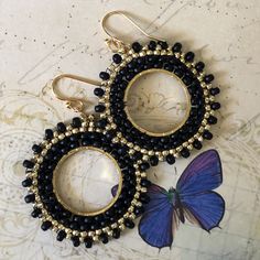 Stunningly beautiful seed bead hoop earrings made with black 8/0 and gold metallic 11.0 seed beads. The french hook earwires and findings are are 14kt gold plated. These very lightweight earrings are handmade by me with each tiny bead individually woven. They measure 2 inches total including the earwires. The hoops are 1.5 inches. These earrings go perfectly with all outfits and occasions. Wear these stunning earrings and get ready for compliments Thanks for looking and please stop by again. Handmade Black Beaded Small Hoop Earrings, Elegant Black Beaded Earrings With Tiny Beads, Black Beaded Round Hoop Earrings, Small Black Hoop Earrings For Jewelry Making, Gold Small Hoop Earrings With Tiny Beads, Gold Round Beaded Earrings With Spacer Beads, Black Beaded Small Hoop Earrings As Gift, Black Beaded Drop Earrings With Gold Beads, Adjustable Gold Beaded Earrings With Black Beads