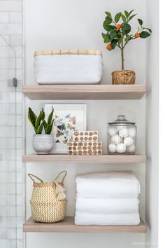 bathroom shelves with towels and plants on them