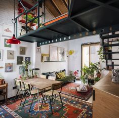 a living room filled with furniture and lots of plants