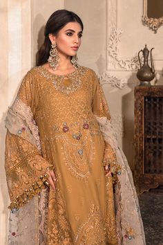 Embroidered Mustard Frock Pakistani Wedding Dresses come in a long frock with embellished work on the base and a net embellished dupatta is paired with it. It can be customized to a lehenga choli instead of the frock. Embroidered Frock: This designer Pakistani wedding dress comes in Embroidered Pure Chiffon Bodice Front, Embroidered Pure Chiffon Front Panels, Pure Chiffon Back Panels, Embroidered Pure Chiffon Sleeves, Pure Chiffon Bodice Back, Embroidered Organza Ghera Patti Front and Back with Gold Organza Gown With Dupatta, Party Wear Dresses With Dabka Work, Net Party Dress With Dabka Work, Gold Organza Gown With Dabka Work, Bollywood Style Embellished Lawn Suit For Wedding, Gold Lawn Wedding Suit With Sheer Dupatta, Wedding Dresses With Dupatta In Net Material, Wedding Dresses With Net Dupatta, Unstitched Net Dress With Dabka Work