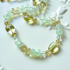 "This luxe gemstone necklace is a stunning piece of jewellery that you will treasure forever. Over four dozen sparkly beads are strung onto light blue silk cord, creating a stunning necklace of subtle colours. A tiny knot separates each stone, which results in a beautiful drape. The stones are about 4mm - 12mm in size, and contain lemon quartz in two shades of yellow, pale green amethyst, rich beer quartz, and mystic green chalcedony. This colour combination is unexpected and so pretty. A small Carnelian Earrings, Green Chalcedony, Small Gift Boxes, Silk Cord, Lemon Quartz, Colour Combination, Green Amethyst, Stunning Necklace, Shades Of Yellow