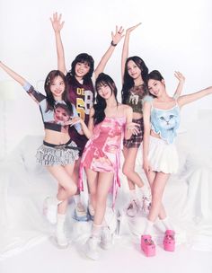 the girls are posing together in front of a white background with their arms up and hands raised