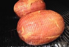 two pieces of meat sitting on top of a grill