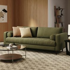 a living room with a green couch and coffee table