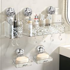 two clear shelves with soaps, toothbrushes and other personal care items on them