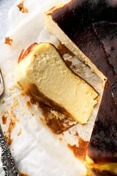 a piece of cake sitting on top of a paper towel next to a knife and fork