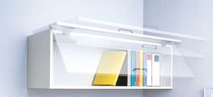 a white shelf with some books on it and a yellow book in the bottom right corner