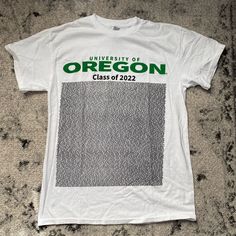 a t - shirt with the university of oregon class of 2012 printed on it sitting on a carpet