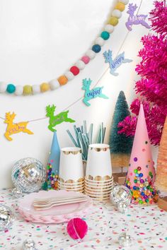 a table topped with plates and cups filled with confetti