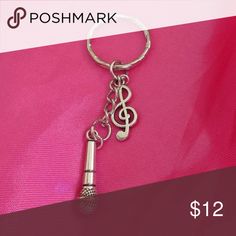 a keychain with a musical note on it and a microphone in the middle