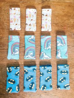 six pairs of socks laid out on a wooden table with different patterns and colors in them