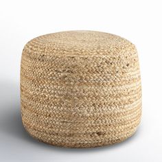 a large round ottoman made out of jute