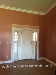 an empty room with two doors and tile flooring on the ground in front of it