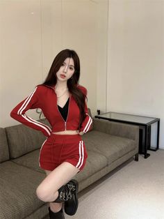 a young woman posing for the camera in a red outfit