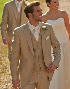 a bride and groom walking down the road