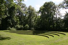 an empty stage in the middle of a grassy field