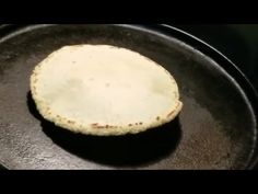 an uncooked tortilla sitting on top of a frying pan