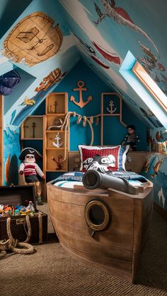 a child's bedroom decorated in blue and brown with lots of toys on the floor