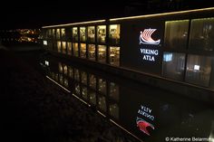 a lit up building at night with the viking atlas logo on it's side