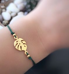 Handmade Bracelet Cord with Gold Plated Charm Monstera Leaf Gold, gift for her. Material 🔹 Leaf charm 24K Gold Plated 🔹 Metal - Brass ( Lead and Nickel Free) 🔹 Nylon Multiple Cord 🔹 Easy to put on and adjust with the adjustable sliding closure. For ANKLET length cord is approximately 36 cm/ 14 inches ( ONE SIZE ) For BRACELET length cord is approximately 28 cm/ 11 inches ( ONE SIZE ) Please select a bracelet or an anklet ------------- (Convo us for any other length or request) -------------- Bracelet Cord, Leaf Bracelet, Gold Gift, Leaf Charms, Monstera Leaf, Handmade Bracelet, Charm Bracelets, Bracelet Gift, 11 Inches