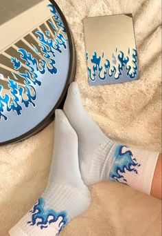 a person laying on a bed with their feet up next to a mirror and socks