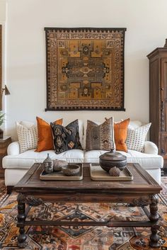 a living room filled with lots of furniture and pillows on top of a rug in front of a painting