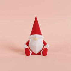 an origami santa claus sitting on the ground