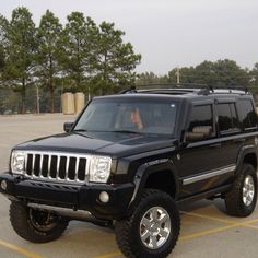 a black jeep parked in a parking lot