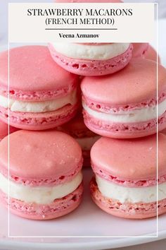 strawberry macaroons are stacked on top of each other with white frosting and pink icing