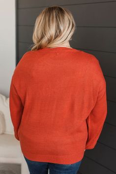 Fit & Details: Oversized, relaxed fit. If in-between sizes, you could size down. Soft knit material with an embroidered "pumpkin" detail along bust Round neckline Drop shoulder sleeves Measurements: Small: Bust 46“ Length 25“ Medium: Bust 48“ Length 26“ Large: Bust 50“ Length 27“ Fabric & Material Care: Hand wash cold. Hang or line dry. 100% Acrylic. *Imported* Model Info: Leah is modeling a large. Britta is modeling a small. Fall Season Solid Color Relaxed Fit Sweater, Relaxed Fit Solid Color Fall Sweater, Solid Color Crew Neck Cardigan For Fall, Orange Textured Knit Top For Fall, Cozy Orange Knit Top, Orange Knit Tops For Fall, Orange Long Sleeve Tops With Ribbed Cuffs, Orange Long Sleeve Top With Ribbed Cuffs, Orange V-neck Knit Sweater