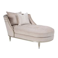 a white chaise lounge chair with pillows on it's back and side legs