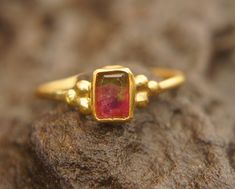 watermelon tourmaline ring, 24k gold ring, 24k gold ring, unique engagement ring, 24k gold gem ring, gold artisan engagement ring, statement ring I love watermelon tourmaline and with this delicate 24k gold setting , it's a refreshing stone breathtaking piece. stone is 6X4.5 mm  watermelon tourmaline I used 24k gold for the setting,  and 22k for the rest of the wire ring (1.4 mm) Please view my full collection of earrings:  https://www.etsy.com/geffenjewelry The jewelry will be packed in a gift Gold Tourmaline Rings, Watermelon Tourmaline Engagement Ring, Gold Ring Unique, Watermelon Tourmaline Ring, Bezel Earrings, Minimal Ring, Wire Ring, Unique Engagement Ring, Dope Jewelry