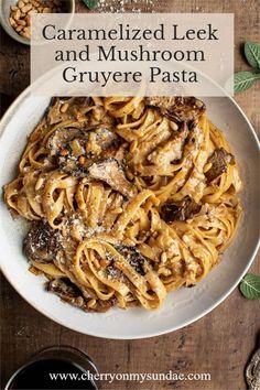 a white plate topped with pasta and mushrooms