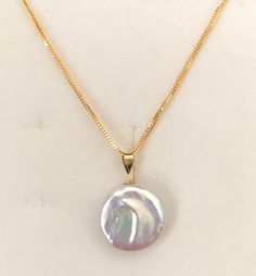 "Natural pinkish white coin pearl pendant with peoples chain necklace set , authentic Gold GOLD PURITY:- 916 GOLD chain 18k Gold coin pearl pendant Chain : 1mm peoples chain Pendant: natural pinkish white coin pearl pendant 16\" inches set Colour : YELLOW GOLD 16\" inches set👇🏽 * 916 gold chain 2.40 grams + 2.5cm 18k gold coin pearl pendant Hallmark: Hallmarked 916 stamp and 750 for 18k gold Hook: 's' hook Design : elegant white pinkish pearl pendant with people's chain necklace set * chain an Cheap Round Pearl Pendant Jewelry, Pearl Necklace With Coin Pendant As Gift, Gold Pearl Necklace With High Luster Round Pendant, Authentic Gold, Solid Gold Necklace, Solid Gold Chains, Coin Pearls, Hook Design, Gold Coin