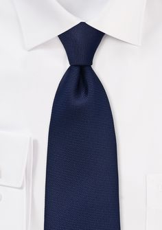 Introducing the Men's Navy Microtexture Necktie, a captivating accessory that combines timeless style with modern sophistication. This necktie features a deep and rich navy blue shade with a subtle microtexture pattern, adding depth and dimension to your ensemble. Its sleek and refined design makes it a versatile choice for any occasion. Pair it with a crisp white or light blue dress shirt for a classic and polished look that is perfect for both formal events and professional settings. Whether y Modern Blue Ties For Formal Occasions, Modern Blue Tie For Business, Modern Blue Ties For Business, Elegant Blue Office Ties, Modern Standard Tie For Office, Elegant Blue Neckwear For Black Tie Occasions, Elegant Blue Neckwear For Black Tie Events, Elegant Navy Accessories For Black Tie Suit, Modern Blue Suit And Tie Accessories For Formal