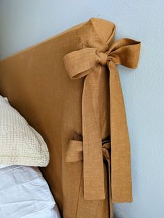 a bed with a bow on the headboard