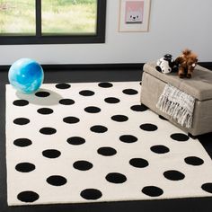 a black and white rug with polka dots on it in a room next to a window