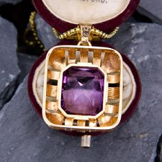 This fabulous large amethyst pendant is centered with a rectangular cut amethyst that is accented with a halo of high polished open gold work. The pendant is crafted in 14k yellow gold and is about 1.25" long. We have added an 18 inch long 14k yellow gold rounded box chain weighing approximately 3 grams. Art Deco Jewelry With Rectangular Pendant As Gift, Art Deco Jewelry With Rectangular Pendant For Gift, Vintage Jewelry With Rectangular Stone For Gift, Elegant Purple Locket Jewelry, Antique Octagon Shaped Jewelry For Gifts, Elegant Purple Rectangular Necklace, Luxury Purple Rectangular Jewelry, Purple Art Deco Necklace For Gift, Purple Rectangular Jewelry For Gifts