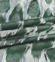 green and white patterned fabric with black stripes