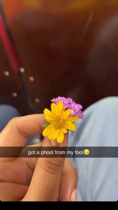 a person holding a flower in their hand with the caption got a photo from my foot